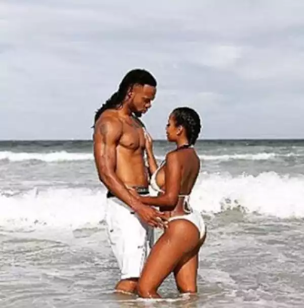Singer Flavour Pictured With A Bikini Clad Model At The Beach, Fans Reacts [See Photos]